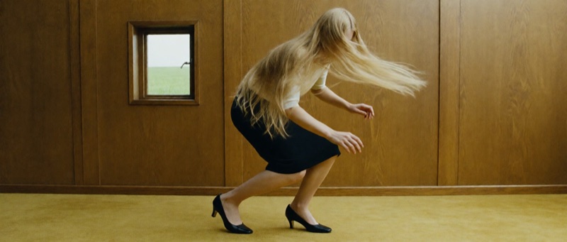 Hair Apparition · by Claire Shin · hair in motion, wood-paneled room, wide composition