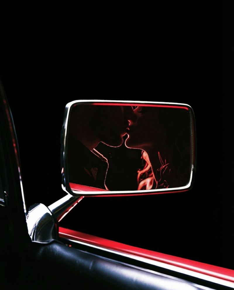 Rearview Kiss · by SQUAD · rearview mirror, red light, intimate portrait