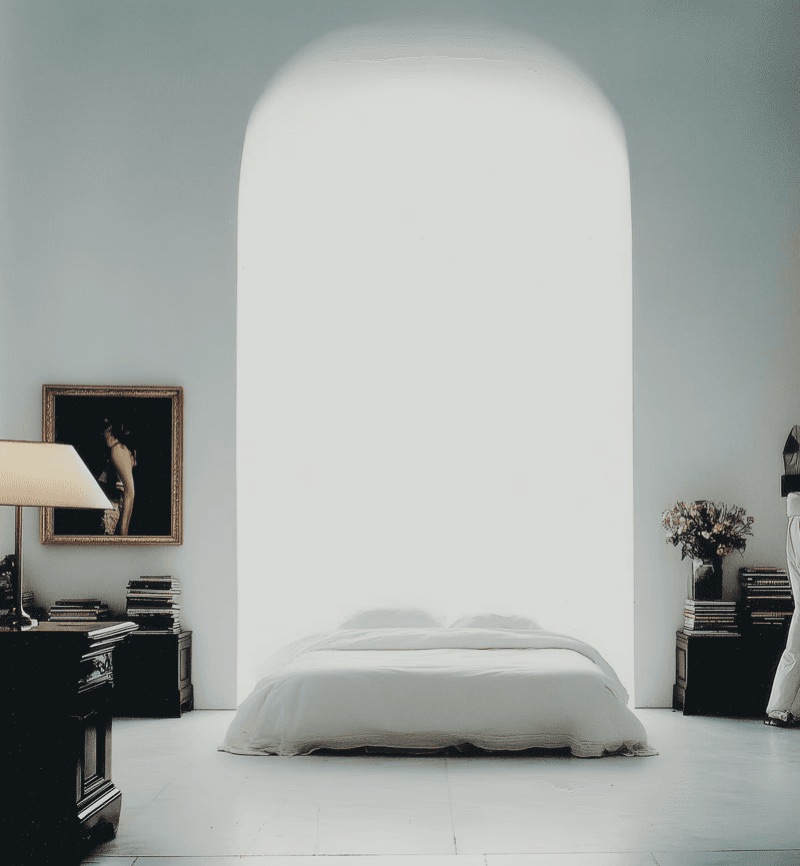 The White Bed · by Jamey Gannon · white bedroom, arched opening, stacked books
