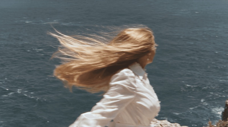 Wind by Water · by Jamey Gannon · windblown hair, white shirt, waterfront